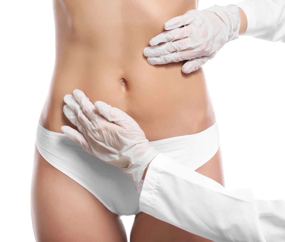 Surgeon examine female body before plastic operation on white background