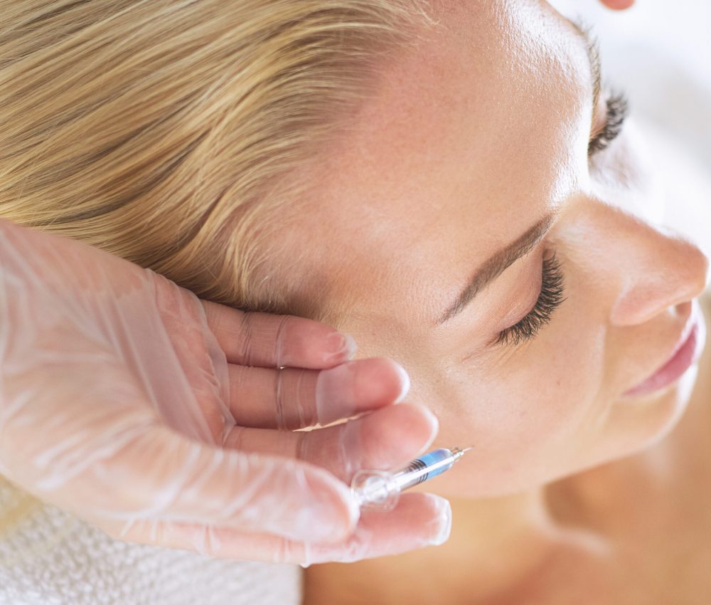 Beautiful woman gets beauty facial injections. Face aging injection. Aesthetic Cosmetology.